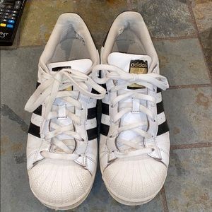 Black and white adidas superstars
